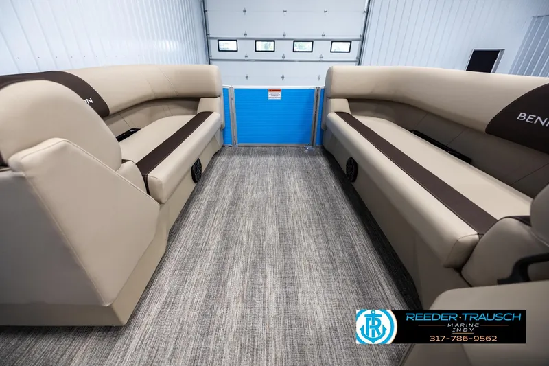Slide: The Image of 2025 Bennington 21 SL pontoon boat interior with beige seating and gray flooring. - 17