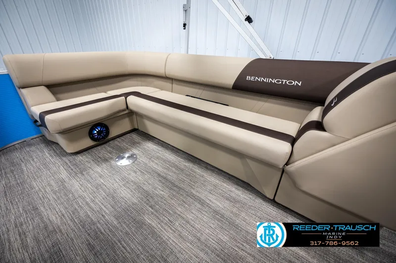 Slide: The Image of 2025 Bennington 21 SL boat interior with beige seating and modern design. - 20