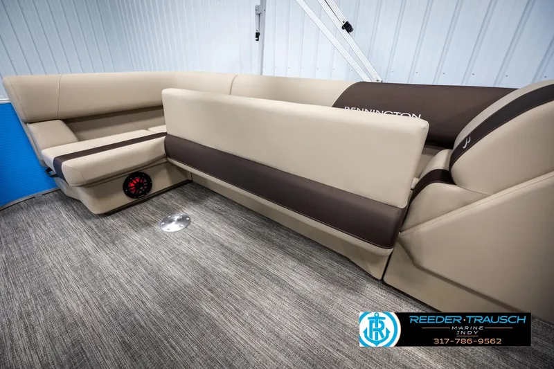 Slide: The Image of 2025 Bennington 21 SL boat interior with beige seating and carpeted flooring. - 21