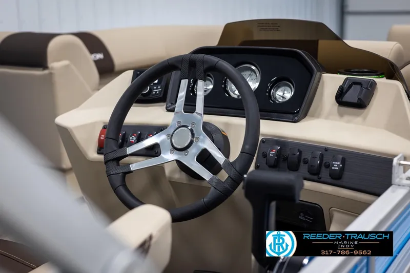 Slide: The Image of Interior view of 2025 Bennington 21 SL boat dashboard with steering wheel and controls. - 24