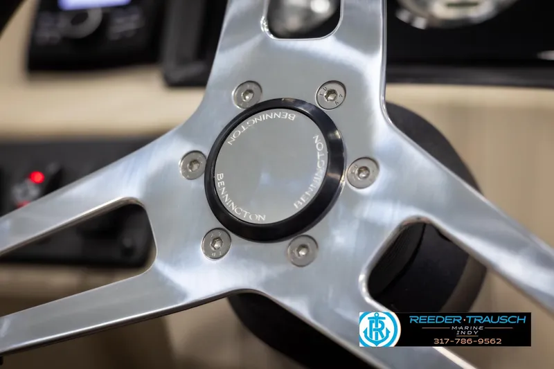 Slide: The Image of Close-up of 2025 Bennington 21 SL steering wheel with Reeder-Trausch Marine logo. - 25