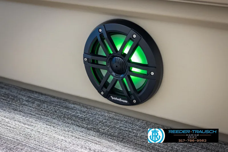 Slide: The Image of Speaker with green LED light on 2025 Bennington 21 SL boat, Reeder-Trausch Marine logo visible. - 36