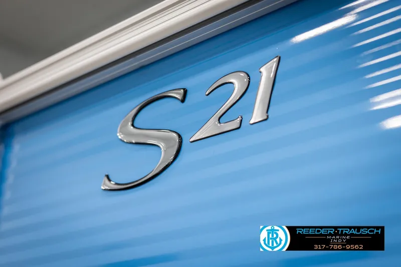 Slide: The Image of 2025 Bennington 21 SL boat with "S21" emblem on blue exterior. - 43