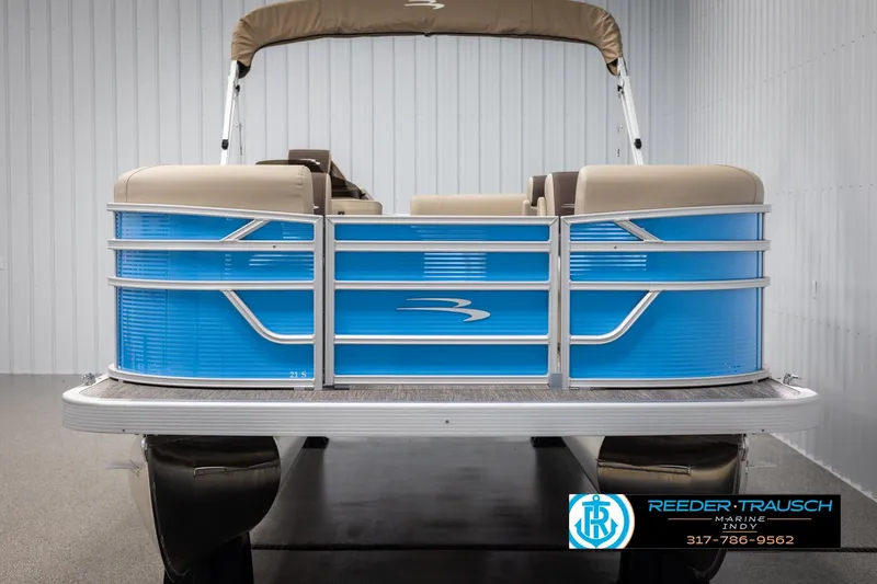 Slide: The Image of 2025 Bennington 21 SL pontoon boat with blue exterior and beige seating in showroom. - 7