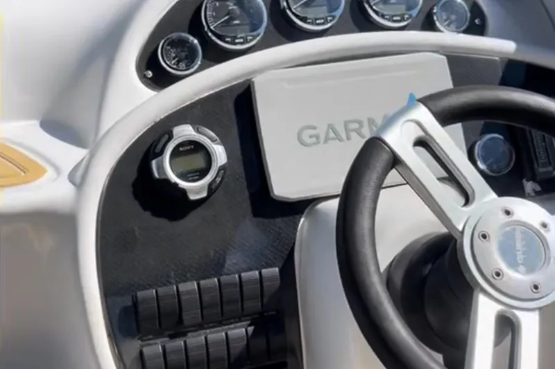 Slide: The Image of 1997 Baja 38 boat dashboard with Garmin navigation and Sony controls. - 12