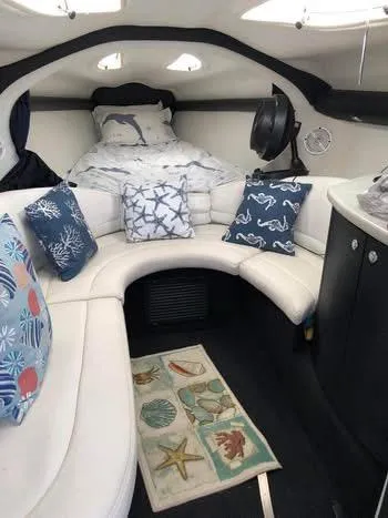 Slide: The Image of 1997 Baha Cruisers 38 interior with nautical-themed decor and cozy seating area. - 18