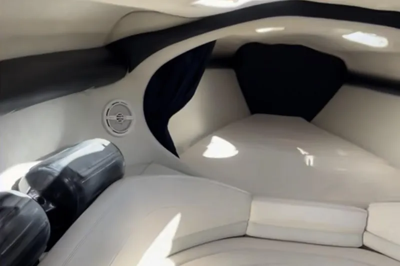 Slide: The Image of Interior cabin of a 1997 Baja 38 boat, featuring cushioned seating and speaker. - 20