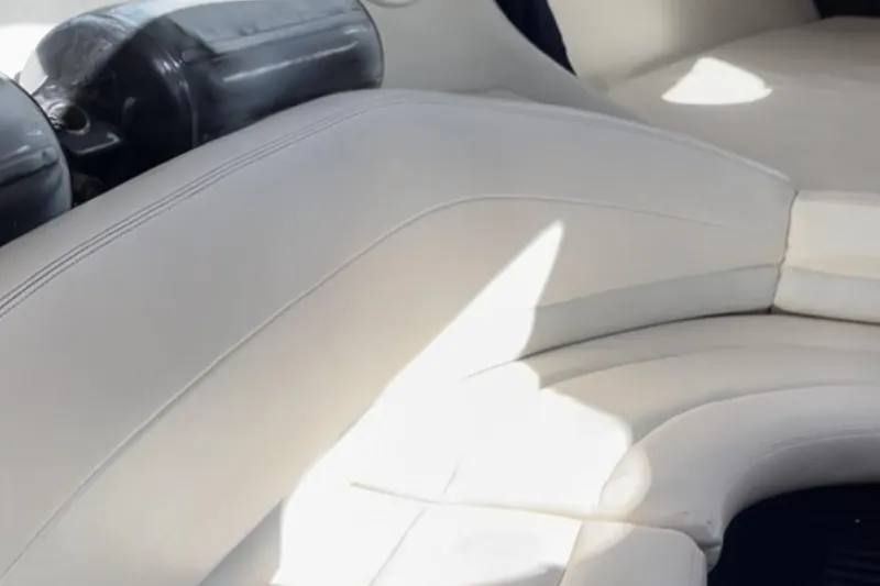 Slide: The Image of 1997 Baja 38 boat interior with white leather seating and black accents. - 22