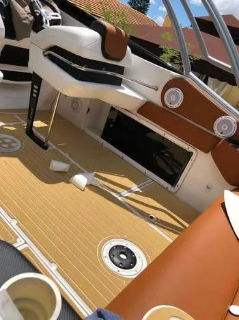 Slide: The Image of 1997 Baha Cruisers 38 boat deck with brown seating and green lawn background. - 4