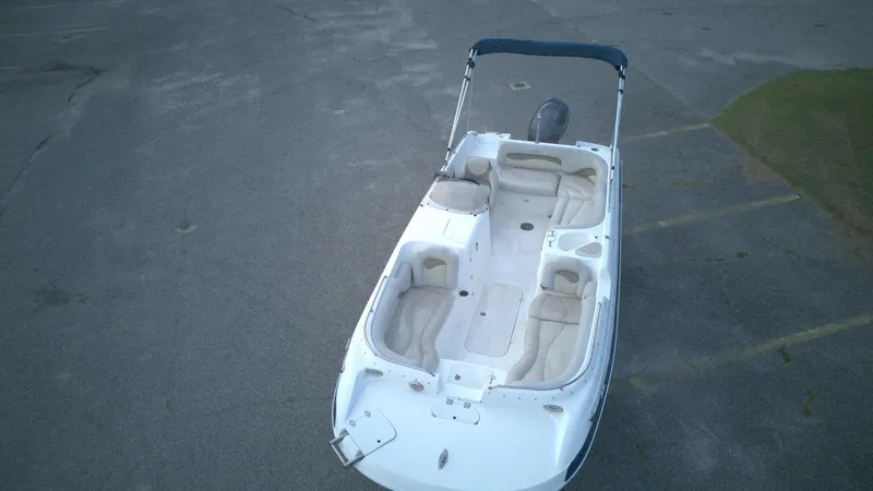 Slide: The Image of 2010 NauticStar 210 SC boat with seating, viewed from above on a paved surface. - 10