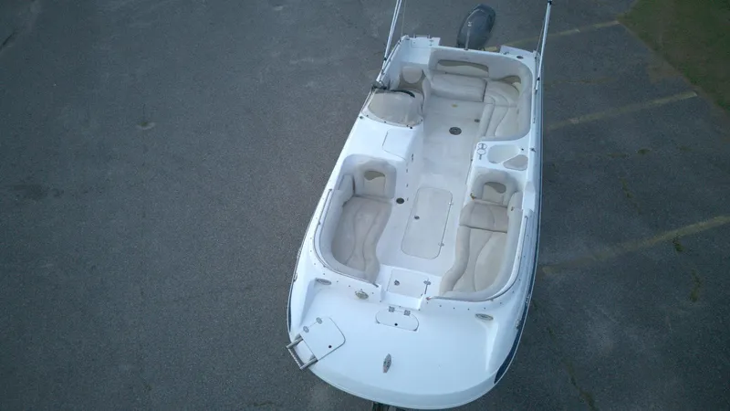 Slide: The Image of 2010 NauticStar 210 SC boat, aerial view, white interior, parked on asphalt. - 3