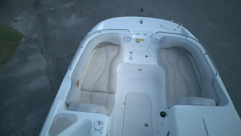 Slide: The Image of 2010 NauticStar 210 SC boat interior with white seating and storage compartments. - 7