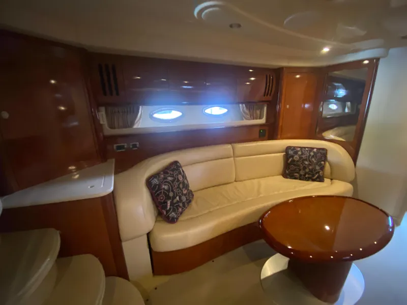 Slide: The Image of Luxurious interior of 2004 Sea Ray 420 Sundancer yacht with leather seating and wooden table. - 39