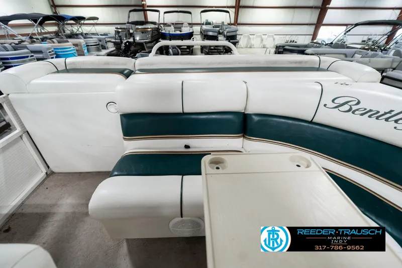 Slide: The Image of 2005 Bentley Pontoons 200 CRUISE interior with white and green seating, cup holders, and logo. - 17