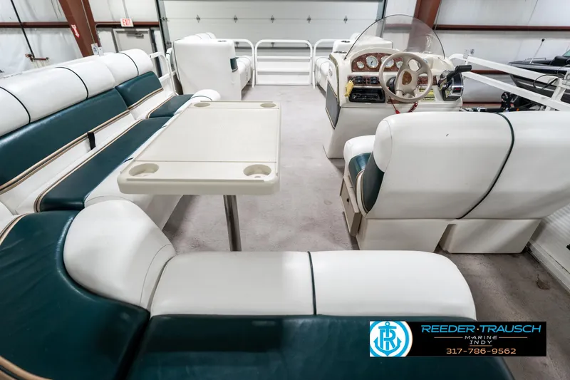 Slide: The Image of 2005 Bentley Pontoons 200 CRUISE interior with seating and steering console in a showroom. - 18