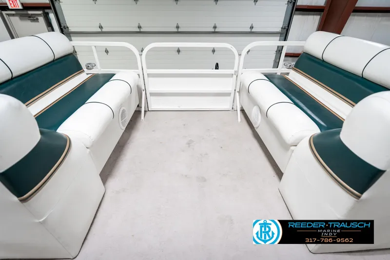 Slide: The Image of 2005 Bentley Pontoons 200 CRUISE interior with white and green seating in a garage. - 20