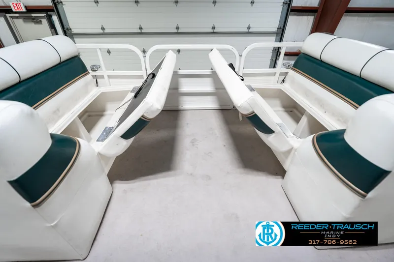 Slide: The Image of 2005 Bentley Pontoons 200 CRUISE interior with green and white seating, open storage compartments. - 21