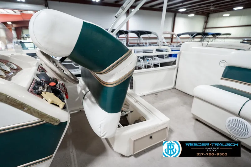 Slide: The Image of 2005 Bentley Pontoons 200 CRUISE interior with green and white seating, steering wheel, and controls. - 23