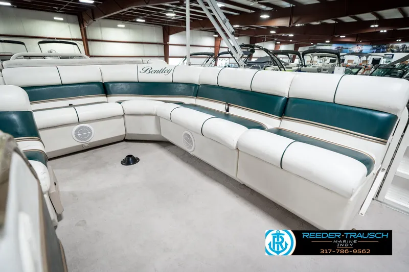 Slide: The Image of 2005 Bentley Pontoons 200 CRUISE interior with white and green seating in a showroom. - 25