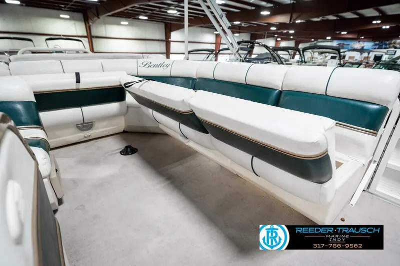 Slide: The Image of 2005 Bentley Pontoons 200 CRUISE interior with white and green seating in a showroom. - 26