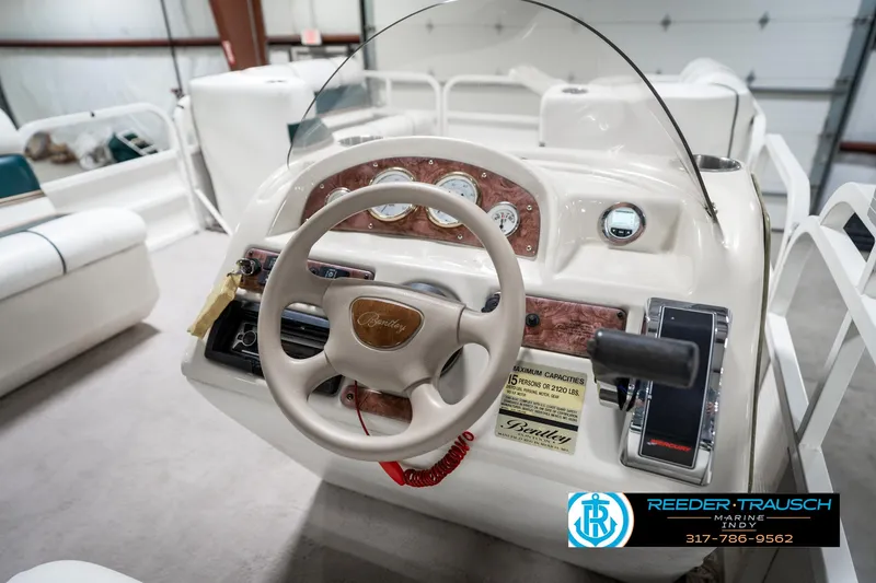 Slide: The Image of 2005 Bentley Pontoons 200 CRUISE steering console with gauges and controls in a showroom. - 28