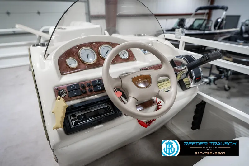 Slide: The Image of 2005 Bentley Pontoons 200 CRUISE dashboard with steering wheel and control panel in showroom. - 29