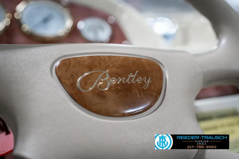 Slide: The Image of Close-up of 2005 Bentley Pontoons 200 CRUISE steering wheel with logo and dashboard. - 30
