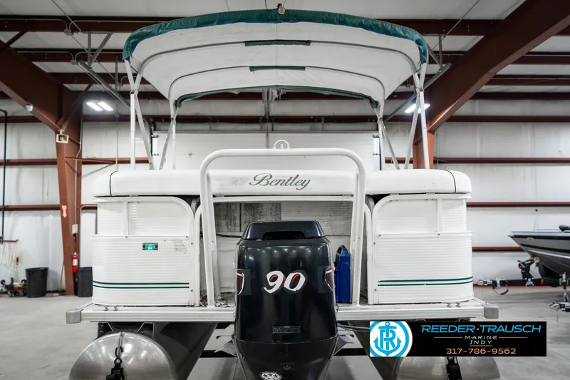 Slide: The Image of 2005 Bentley Pontoons 200 CRUISE in indoor storage, featuring a 90 HP outboard motor. - 8
