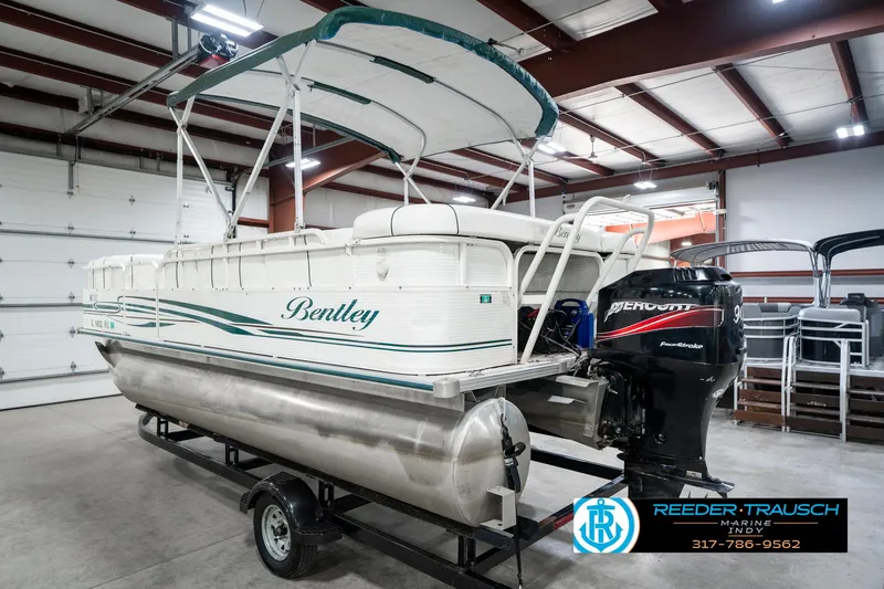 Slide: The Image of 2005 Bentley Pontoons 200 CRUISE boat in indoor storage with Mercury outboard motor. - 9