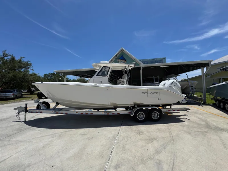 The Image of 2026 Solace 30 CS boat on trailer under clear blue sky. - 1
