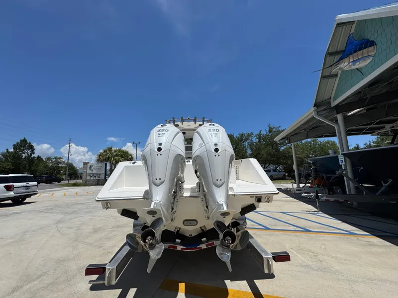 Slide: The Image of 2026 Solace 30 CS boat with dual outboard engines in a sunny marina. - 14