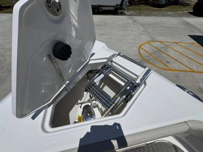 Slide: The Image of Open hatch on 2026 Solace 30 CS boat showing storage compartment and ladder. - 20