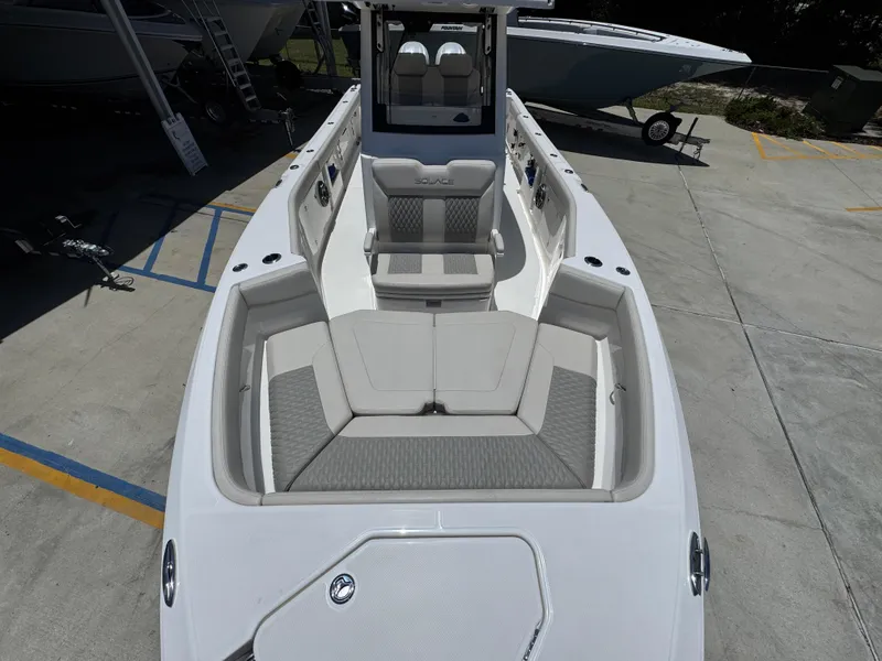 Slide: The Image of 2026 Solace 30 CS boat interior with cushioned seating and sleek design. - 21