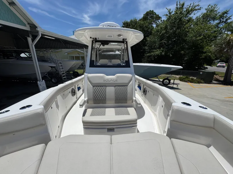 Slide: The Image of 2026 Solace 30 CS boat with spacious seating and modern design in a marina setting. - 23