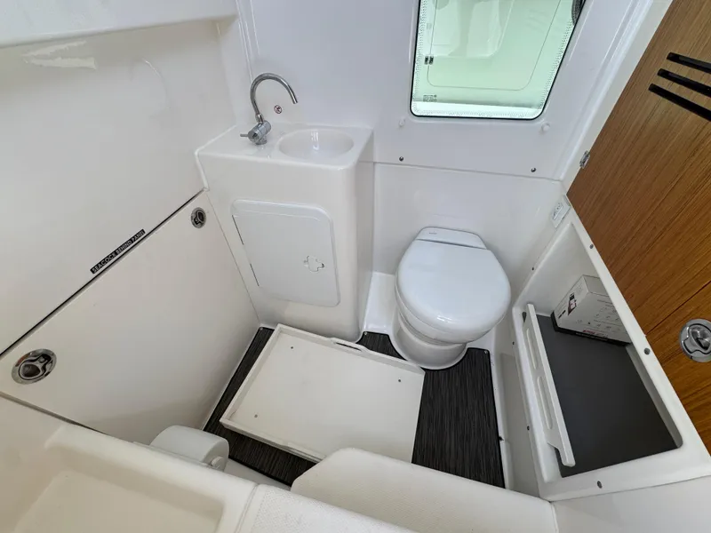 Slide: The Image of Compact bathroom in 2026 Solace 30 CS boat with toilet, sink, and storage. - 27
