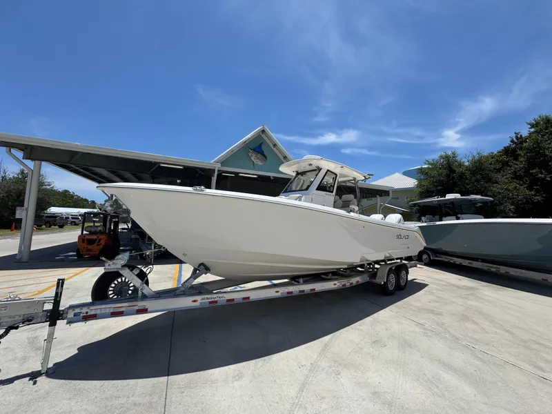 Slide: The Image of 2026 Solace 30 CS boat on trailer under clear blue sky. - 3