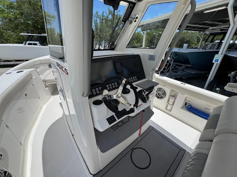 Slide: The Image of 2026 Solace 30 CS boat cockpit with modern controls and seating. - 30