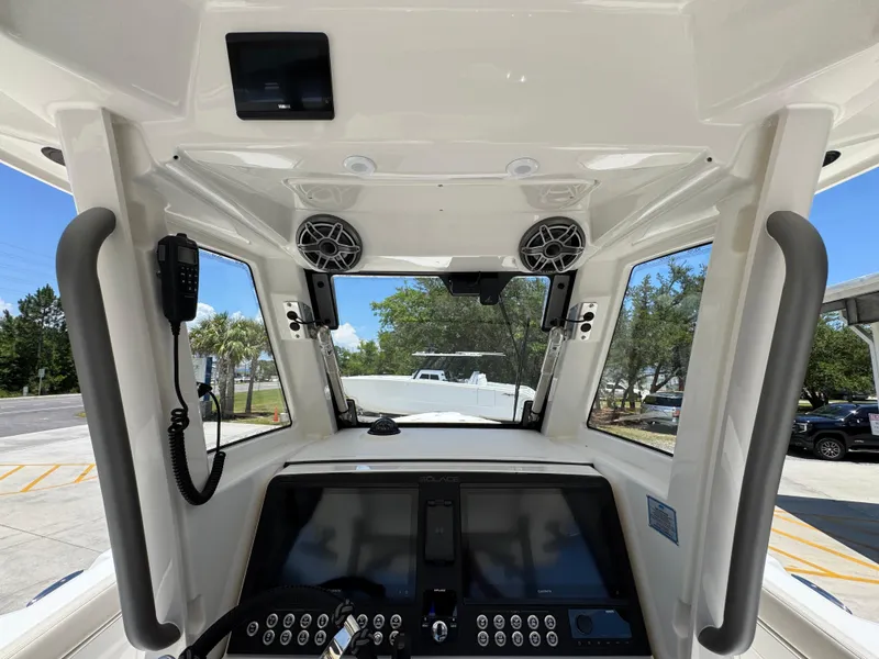 Slide: The Image of Interior view of 2026 Solace 30 CS boat cockpit with modern controls and speakers. - 32