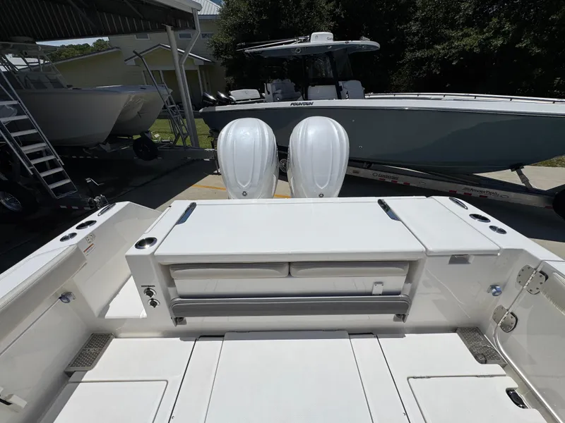 Slide: The Image of 2026 Solace 30 CS boat with dual engines, docked near other vessels. - 37