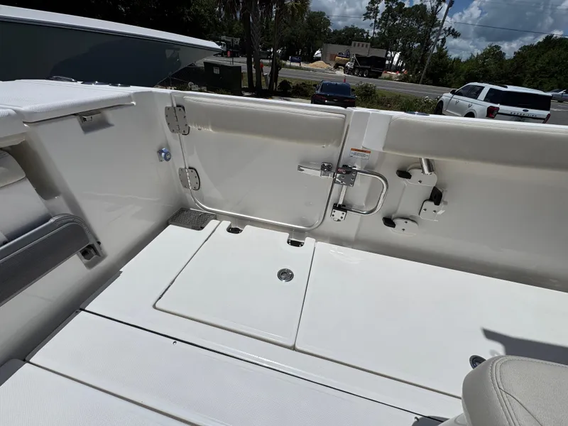 Slide: The Image of Interior view of a 2026 Solace 30 CS boat, featuring sleek white seating and deck. - 38