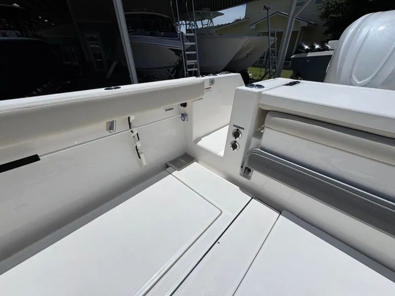 Slide: The Image of 2026 Solace 30 CS boat interior with white seating and storage compartments. - 39