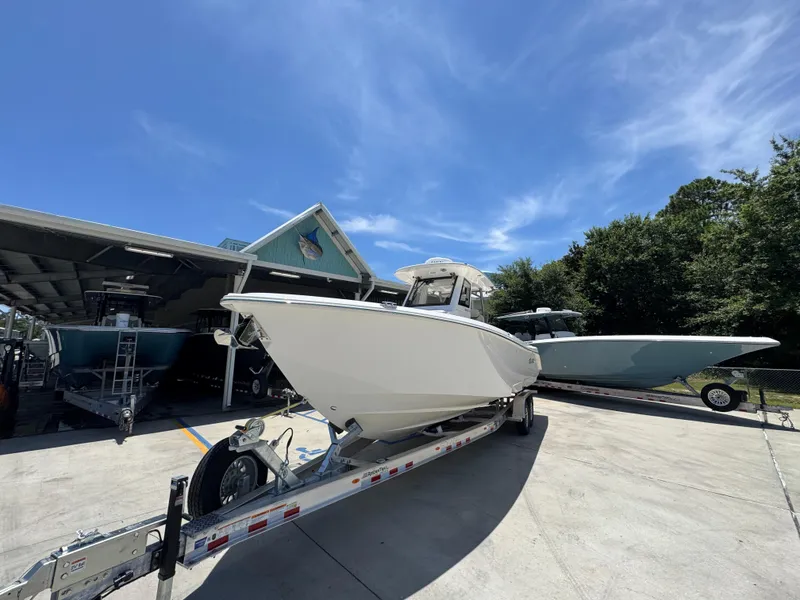 Slide: The Image of 2026 Solace 30 CS boat on trailer under clear blue sky. - 4