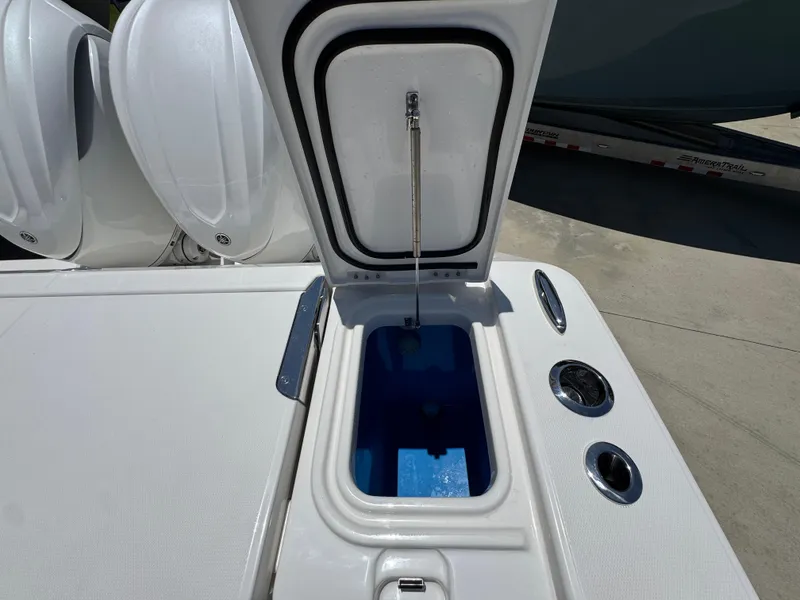 Slide: The Image of Open hatch on 2026 Solace 30 CS boat, revealing storage compartment. - 41