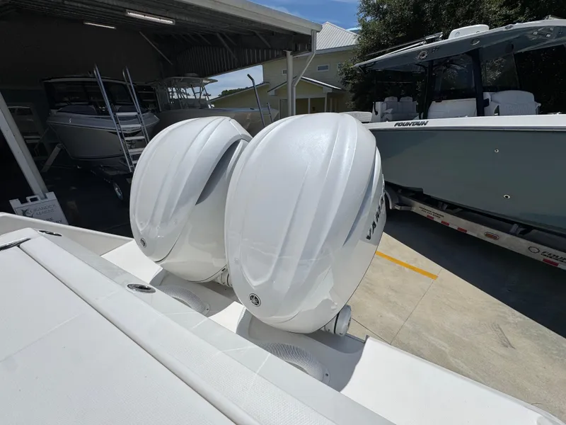 Slide: The Image of Twin outboard engines on a 2026 Solace 30 CS boat in a marina setting. - 42