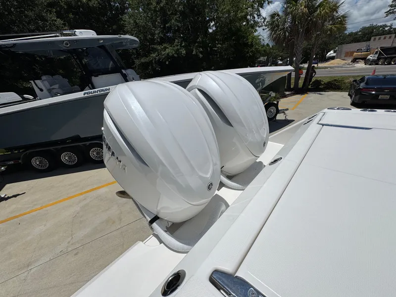 Slide: The Image of 2026 Solace 30 CS boat with dual outboard engines in a sunny outdoor setting. - 43