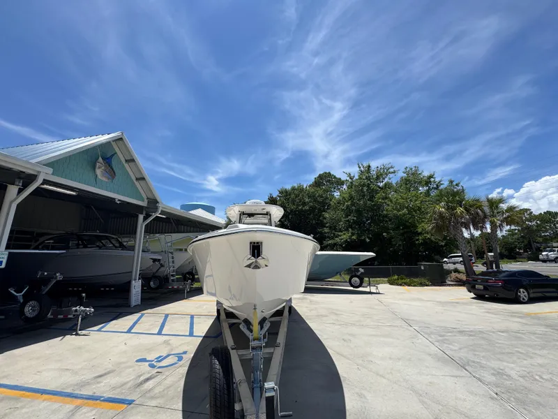 Slide: The Image of 2026 Solace 30 CS boat on trailer under clear blue sky. - 6