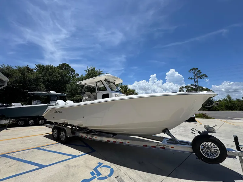 Slide: The Image of 2026 Solace 30 CS boat on trailer under clear blue sky. - 8