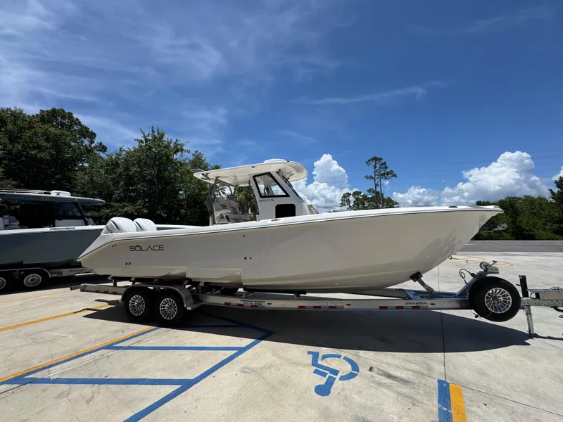 Slide: The Image of 2026 Solace 30 CS boat on trailer under clear blue sky. - 9