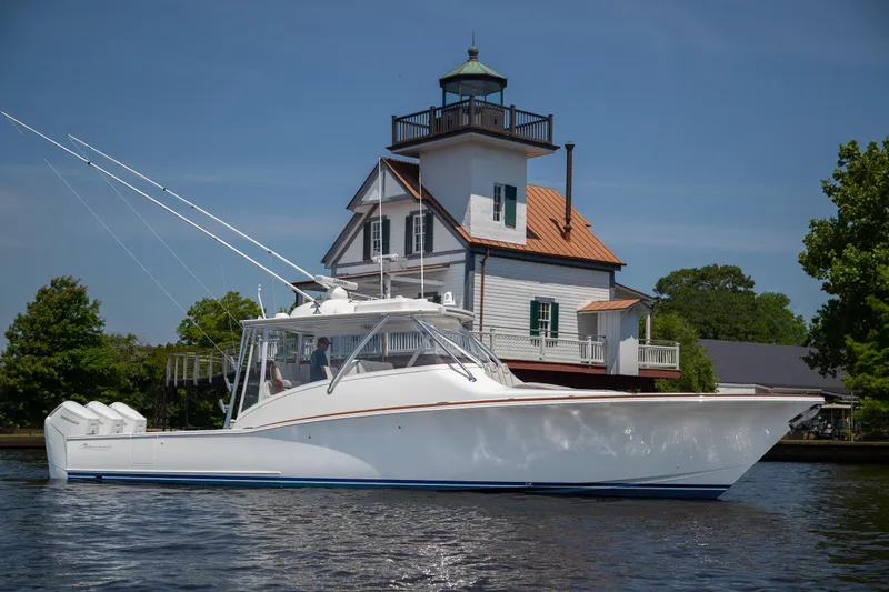 The Image of 2025 Albemarle 45 Carolinian yacht near a historic lighthouse on a sunny day. - 0