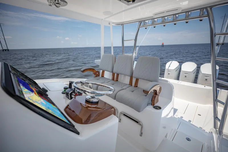 Slide: The Image of 2025 Albemarle 45 Carolinian boat cockpit with modern controls and ocean view. - 17